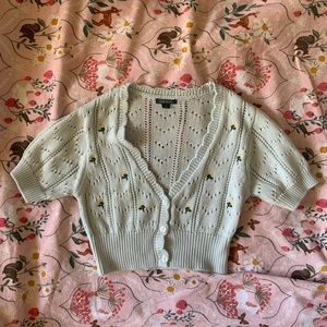 crocheted baby blue top with yellow embroidered flowers and button detailing!